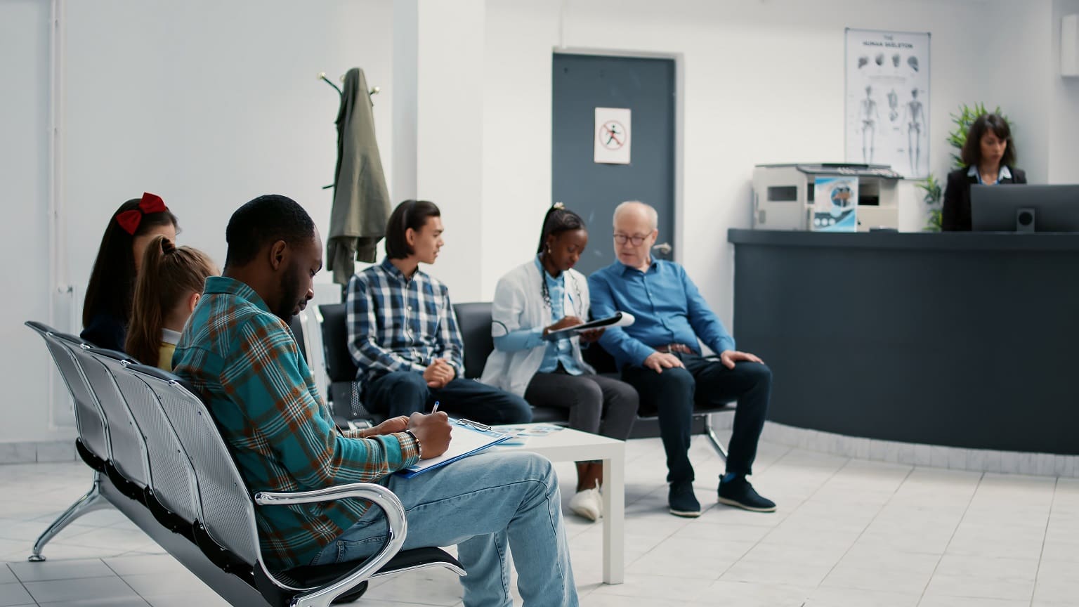 Diverse group of patients sitting in waiting room at hospital